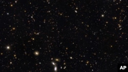 More than 12 billion years of cosmic history are shown in this unprecedented, panoramic, full-color view of thousands of galaxies in various stages of assembly