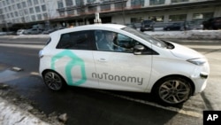 FILE - An autonomous vehicle is driven by an engineer on a street in an industrial park in Boston, Jan. 10, 2017. 