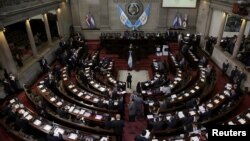 FILE - Congress members are seen as they voted to preserve President Jimmy Morales's (not pictured) immunity from prosecution, in Guatemala City, Guatemala, Sept. 11, 2017. 