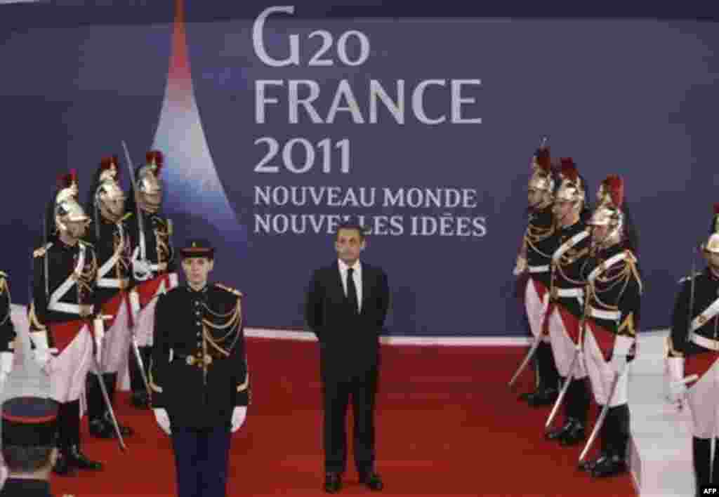 French President Nicolas Sarkozy, center, waits for China's President Hu Jintao during arrivals for the G20 summit in Cannes, France on Wednesday, Nov. 2, 2011. Greek Prime Minister George Papandreou was flying to the chic French Riviera resort of Cannes 