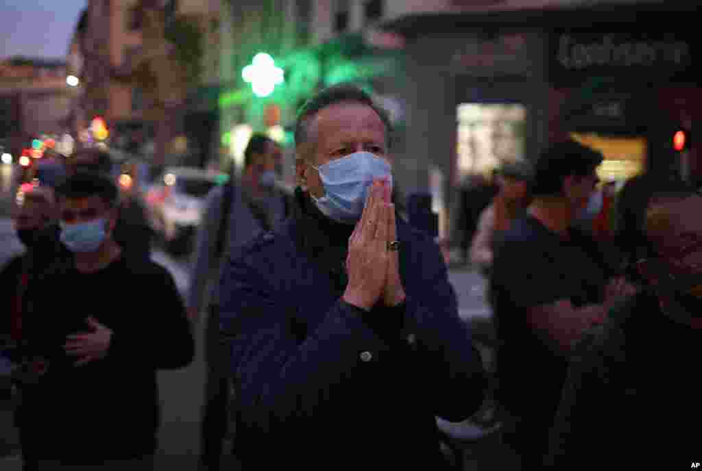 A man prays in the street outside the Notre Dame church in Nice, southern France, after a knife attack.
