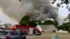 Crews work to contain a wildfire in the Carolina Forest area, west of the coastal resort city of Myrtle Beach, South Carolina, March 2, 2025. (WMBF-TV via AP)