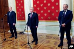 FILE - Russian President Vladimir Putin, center, Azerbaijan's President Ilham Aliyev, left, and Armenian Prime Minister Nikol Pashinyan speak to media after talks in Kremlin in Moscow, Russia, Jan. 11, 2021.
