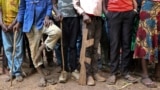 FILE - Former child soldiers stand in line for registration with UNICEF to receive a release package in Yambio, South Sudan, Feb. 7, 2018.