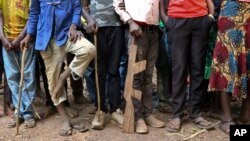 FILE - Former child soldiers stand in line for registration with UNICEF to receive a release package in Yambio, South Sudan, Feb. 7, 2018.