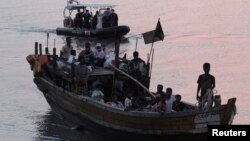 Rohingya refugees, who were intercepted by Malaysian Maritime Enforcement Agency off Langkawi island, are escorted in their boat as they are handed over to immigration authorities, in Malaysia, April 3, 2018.