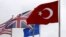 FILE - A Turkish flag, right, flies among others flags of NATO members at the Alliance headquarters in Brussels, Belgium, July 28, 2015. 