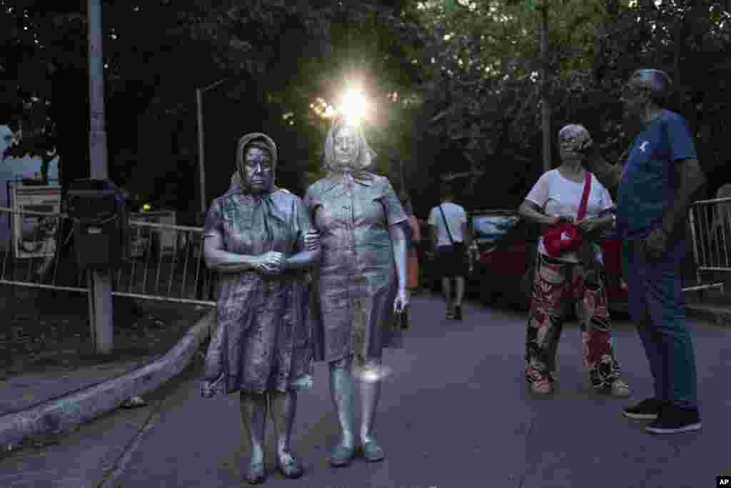 Women perform dressed as members of Mothers of Plaza as they protest against layoffs announced by the government of Javier Milei at the Haroldo Conti Cultural Center in Buenos Aires, Argentina, Jan. 4, 2025.