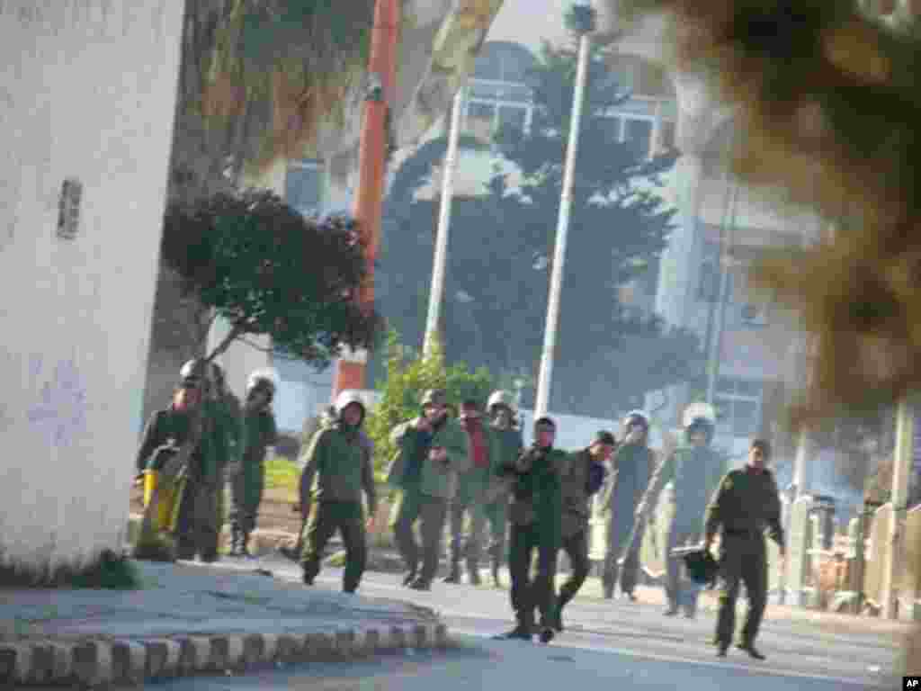 Pro-government Syrian police point their guns towards protesters during demonstrations against Syria's President Bashar al-Assad in Adlb on December 30, 2011. (Reuters)