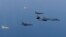 FILE - A U.S. Air Force B-1B Lancer leads a formation of Republic of Korea Air Force F-15K Slam Eagles and F-16 Fighting Falcons during a bilateral mission into South Korean airspace March 21, 2017.