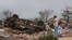 John Warner surveys the damage near a friend's mobile home in the Steelman Estates Mobile Home Park, destroyed in a tornado, near Shawnee, Oklahoma, May 20, 2013. 