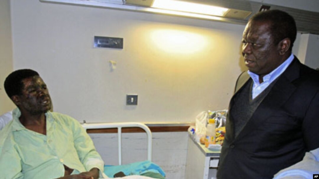 Zimbabwe's Prime Minister Morgan Tsvangirai visits Movement For Democratic Change youth leader Yaya Kassim, attacked while visiting MDC supporters, at a hospital in the capital Harare, August 5, 2011.