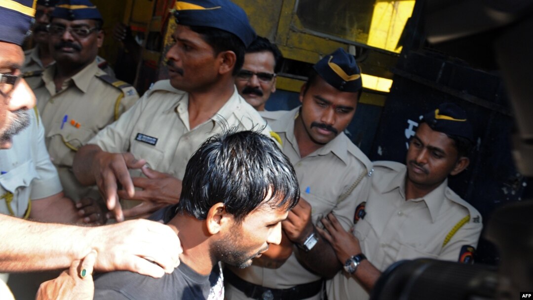 Salah seorang pelaku pemerkosaan, Siraj Rehmat Khan, digiring ke mobil polisi untuk dibawa ke pengadilan di Mumbai (4/4).