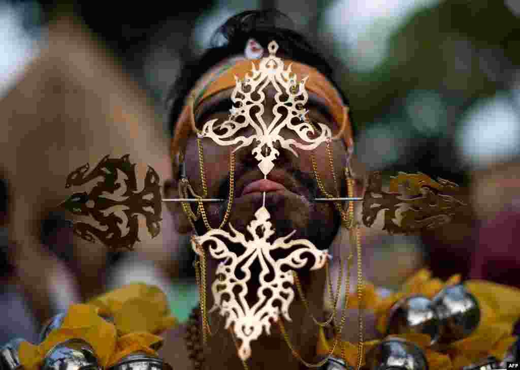 A Hindu devotee&#39;s tongue is pierced before making his way towards the Hill Top Murugan temple during the colorful annual Thaipusam festival, one of the world&#39;s most extreme displays of religious devotion, in Georgetown on the Malaysian island of Penang.