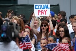 Fans along the parade route chant for equal pay as they wait for the team during the ticker-tape parade for the U.S. women's national soccer team down the canyon of heroes in New York City, July 10, 2019. (Brad Penner-USA TODAY Sports)