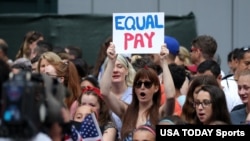  Fans along the parade route chant for equal pay as they wait for the team during the ticker-tape parade for the United States women's national soccer team down the canyon of heroes in New York City, July 10, 2019. (Brad Penner-USA TODAY Sports)