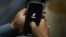 FILE - A man opens social media app TikTok on his cellphone in Islamabad, Pakistan, July 21, 2020.