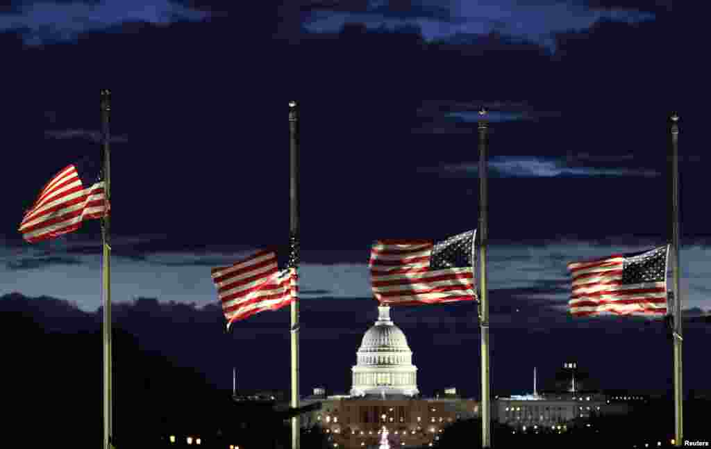 With the U.S. Capitol in the distance, flags fly at half-staff at the Washington Monument on the National Mall following the death of former U.S. President Jimmy Carter, in Washington, Dec. 30, 2024.