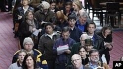 Job seekers stand in line during a Career Expo job fair, in Portland, Oregon, March 7, 2012. 