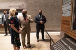 Jill Biden pauses at the The Point of Pines Plantation Slave Cabin during a visit to the National Museum of African American History and Culture with Lonnie Bunch, Secretary of the Smithsonian, center, and museum director Kevin Young, May 14, 2021.