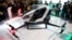 FILE - The EHang 184 autonomous aerial vehicle is unveiled at the EHang booth at CES International in Las Vegas, Jan. 6, 2016. The drone is large enough to fit a human passenger. 