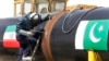 FILE - An Iranian worker welds two gas pipes at the beginning of construction of a pipeline to transfer natural gas from Iran to Pakistan, in southeastern Iran, near the Pakistani border, March 11, 2013. 