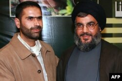FILE - An undated handout photo released by Hezbollah on telegram on January 8, 2024, shows Hezbollah Military Commander Wissam Hassan Tawil, known as Jawad (L), greeting Hezbollah Chief Hassan Nasrallah at an undisclosed location.