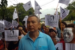 FILE - Somyot Pruksakasemsuk, 56, a high-profile Thai activist jailed for insulting the country's monarchy, stands next to his supporters after his release from a Bangkok prison in Thailand, April 30, 2018.