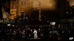 Pope Francis recites his prayer at the end of the Via Crucis (Way of the Cross) torchlight procession in front of the Colosseum on Good Friday, a Christian holiday commemorating the crucifixion of Jesus Christ and his death in Rome, Italy, March 30, 2018.