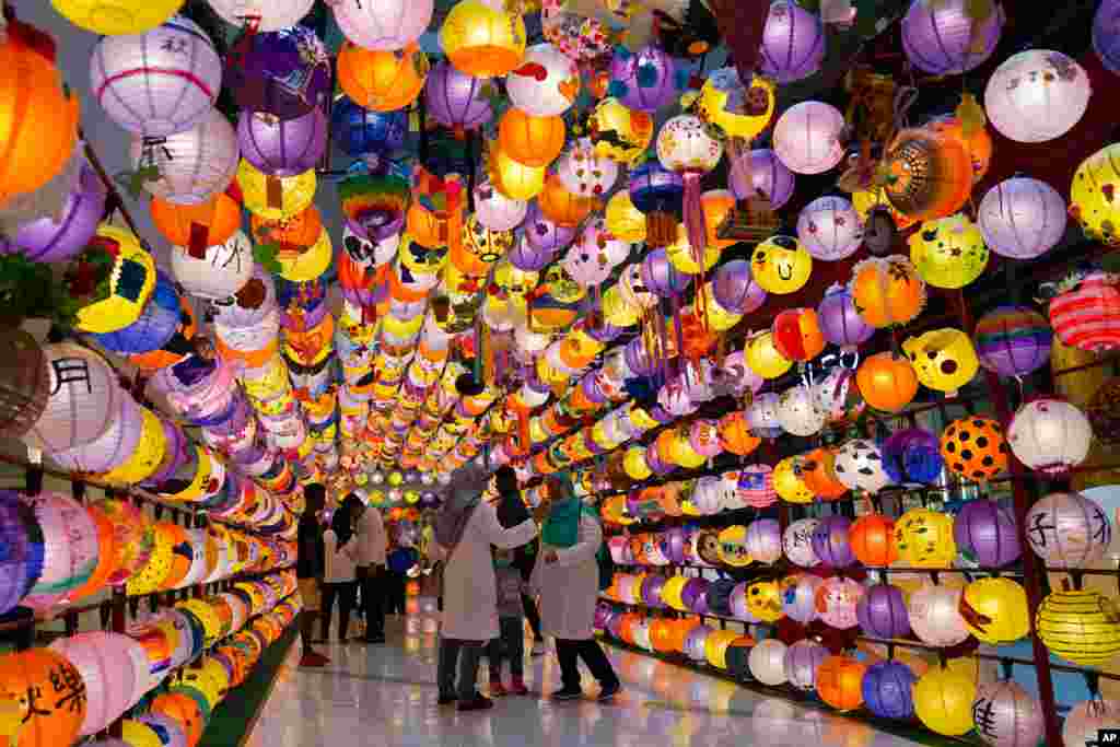Muslim shoppers take a picture of lantern decoration for Mid-Autumn Festival at a shopping mall in Kuala Lumpur, Malaysia, Sept. 14, 2019.