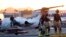Firefighters work around the site of a crashed Learjet at Scottsdale Airport after it collided with a parked plane Feb. 10, 2025, in Scottsdale, Ariz. 