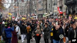 Thousands take part in a demonstration against COVID-19 restrictions in Amsterdam, Netherlands, Nov. 20, 2021. 