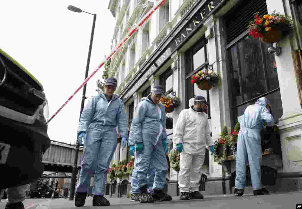 Forensic police investigate around the Borough Market and London Bridge area of London, June 5, 2017.