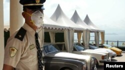 FILE - A security guard stands at a luxury flat in Hong Kong. 