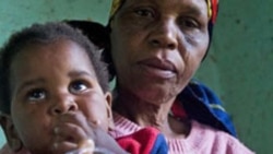 A child with HIV is given medication by a care-giver in Durban, South Africa.