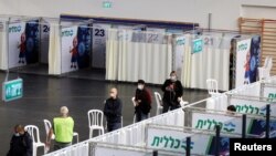 FILE - People queue to receive a vaccine against COVID-19 at a makeshift vaccination site in Petah Tikva, Israel, Jan. 28, 2021.