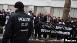 FILE - Fans of the German-language rock band Frei.Wild protest against the band's expulsion from the nominations of the Echo Music Awards after claims their lyrics contained references to right-wing ideas, outside the Messe Berlin trade fair grounds.
