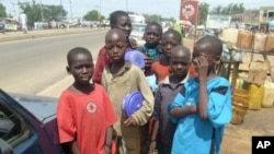 A group of child beggars stand in the streets of Kano, Nigeria on 17 Nov 2009