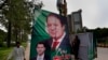 Pakistani workers install a huge billboard of deposed Prime Minister Nawaz Sharif on the planned route of his rally on a highway in Islamabad, Pakistan, Aug. 8, 2017.