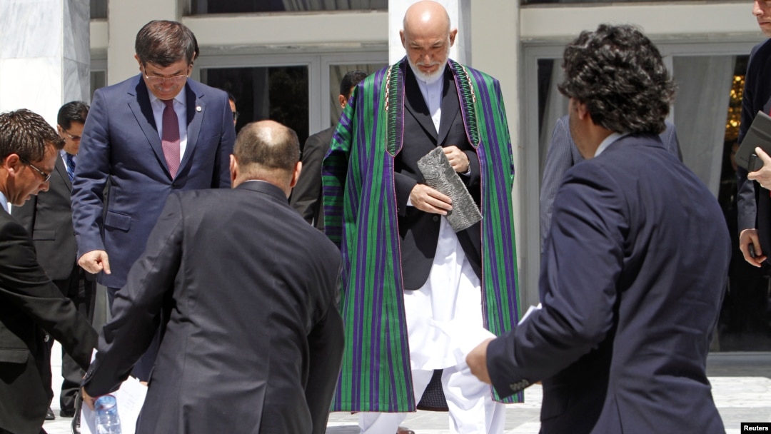 Afghan President Hamid Karzai (C) arrives for a group photo with the foreign attendees of the Asia Ministerial Conference in Kabul, June 14, 2012. 