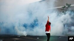 Police move toward a protester after curfew May 30, 2020, in Minneapolis, Minnesota.