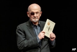 FILE - Salman Rushdie poses for a portrait to promote his book "Knife: Meditations After an Attempted Murder," at the Deutsches Theater in Berlin, May 16, 2024.