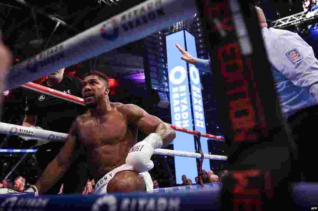 Moyi Grande-Bretagne Anthony Joshua azali kotelema nsima na makofi ya moyi Grande-Bretagne mosusu Daniel Dubois na bitumba ya ba poids lourds ya nkamba ya molongo ya IBF na stade ya Wembley, Londres, Sanza 21 2024. (Photo by Adrian Dennis / AFP) 