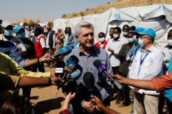 FILE - U.N. High Commissioner for Refugees Filippo Grandi talks to the media at Um Rakuba refugee camp, which houses Ethiopian refugees fleeing fighting in the Tigray region, on the Sudan-Ethiopia border, Sudan, Nov. 28, 2020.