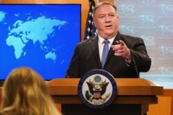 FILE - In this Nov. 10, 2020, file photo, Secretary of State Mike Pompeo gestures toward a reporter while speaking at the State Department in Washington.