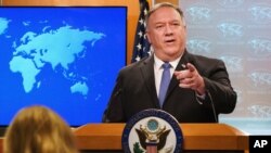 FILE - Then-Secretary of State Mike Pompeo gestures toward a reporter while speaking at the State Department in Washington, Nov. 10, 2020.