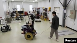 A Korea Institute of Machinery and Materials researcher controls a wheelchair with stiffness-variable "morphing" wheels in Daejeon, South Korea, Nov. 5, 2024.