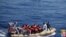 This handout picture released by the Italian Navy on June 6, 2014 shows migrants on boats being arrested and rescued by the Italian army off the coast of Sicily. The Italian navy on June 6 said it had rescued around 2,500 asylum-seekers in the Mediterranean.