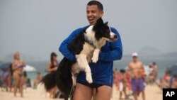 Coach Gustavo Rodrigues celebrates a point with his trainee — a border collie named Floki — as they play footvolley, a combination of soccer and volleyball, in Rio de Janeiro, Sept. 8, 2024.