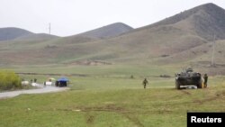 Kyrgyz and Uzbek troops are seen in a disputed area near the town of Kerben, Kyrgyzstan, March 25, 2016. 